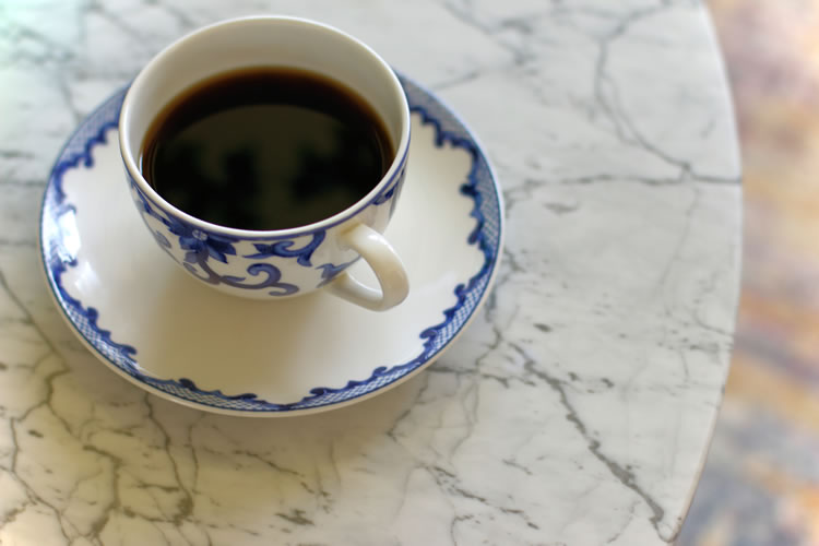 White marble surface of Mara coffee table perfect for morning coffee