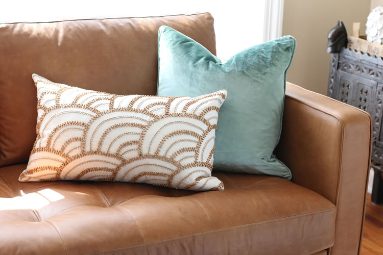 Close-up of the Sven sofa armrest from Article in Charme Tan leather