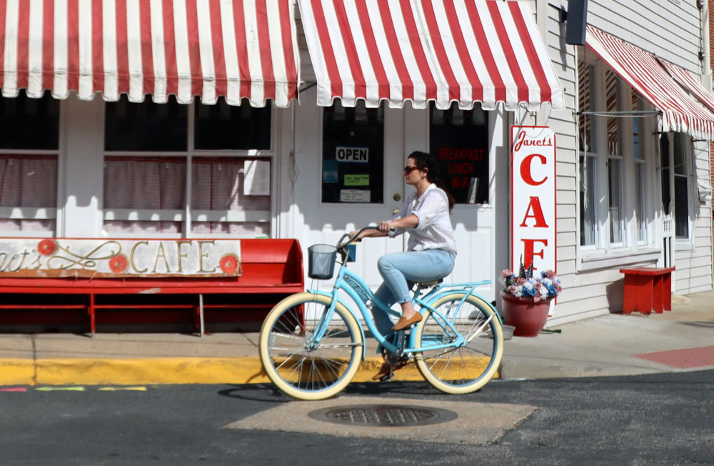 A woman leisurely riding a bicycle as part of her plan to achieve her fitness goals