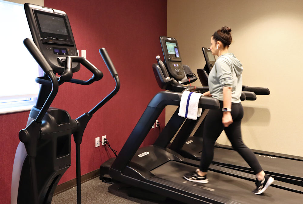 Compact travel fitness equipment including resistance bands, yoga mat, and water bottle packed for convenient hotel workouts