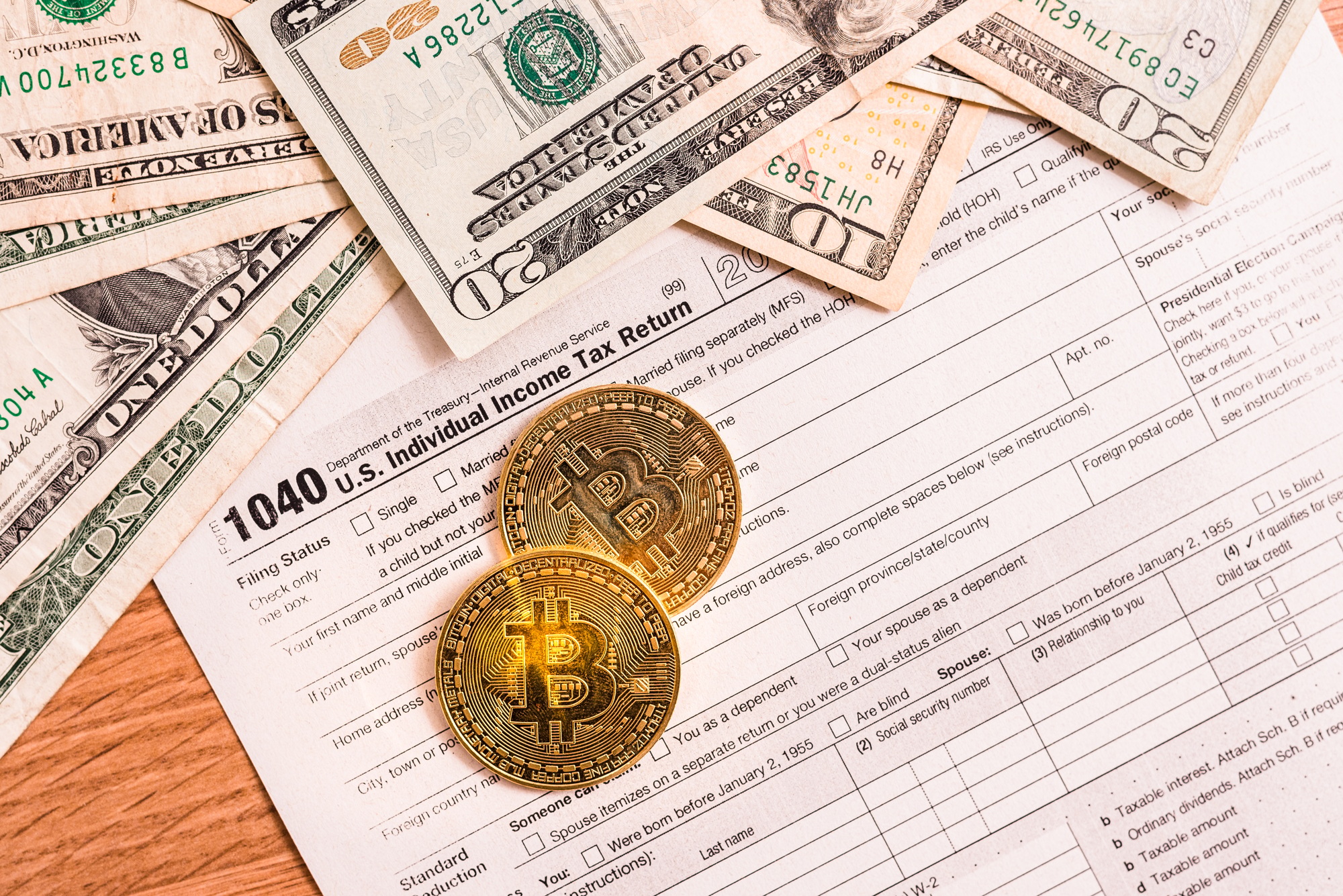 Form 1040 for 2020 with bitcoin coins to declare income generated by investments in cryptocurrencies